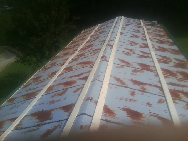 Rusted metal roof panels with new wood purlins before replacement — Storm Damage Roof Repair in Marcus Hook by Roofing Brothers
