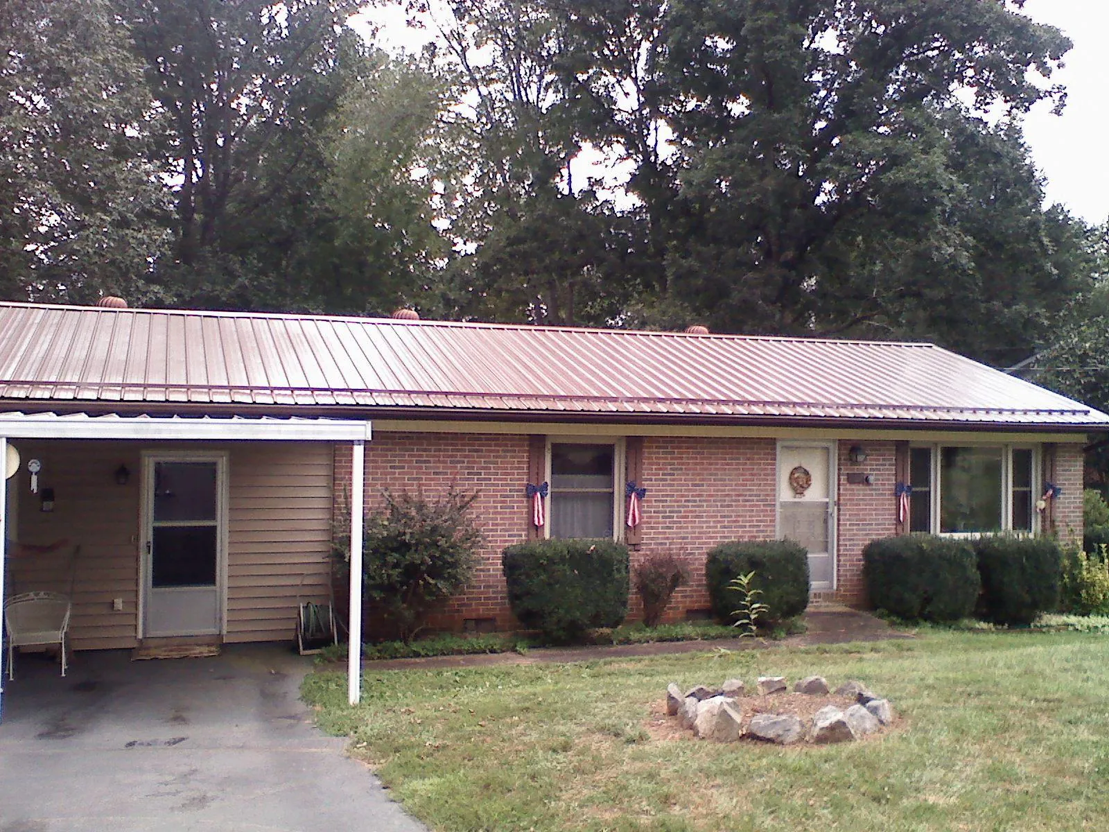 Bronze metal roof and carport on a brick ranch home — Roof Repair work by our crew in Marcus Hook
