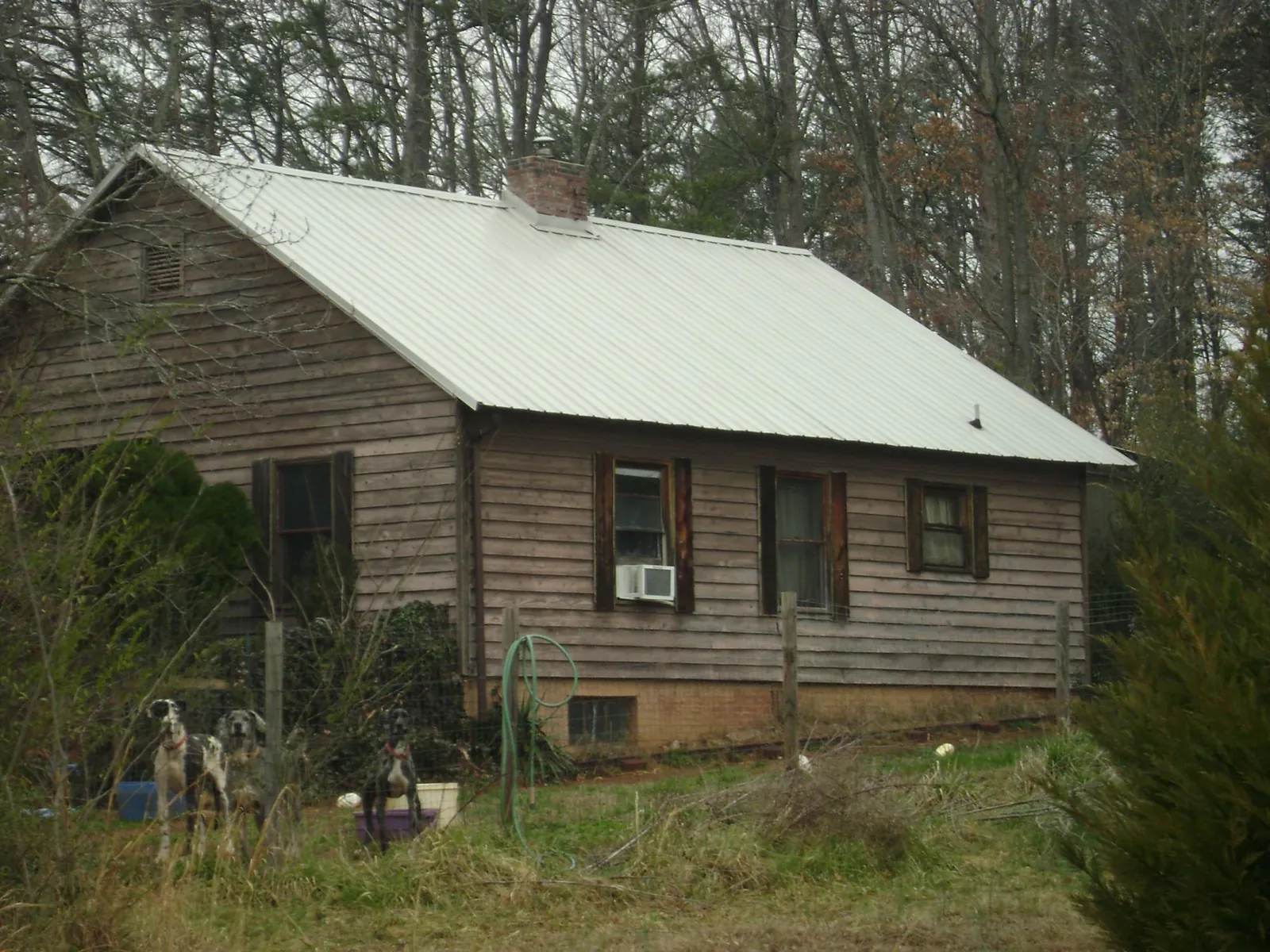 White metal roof on an old wood sided farmhouse, from a Metal Roof Installation job in Marcus Hook